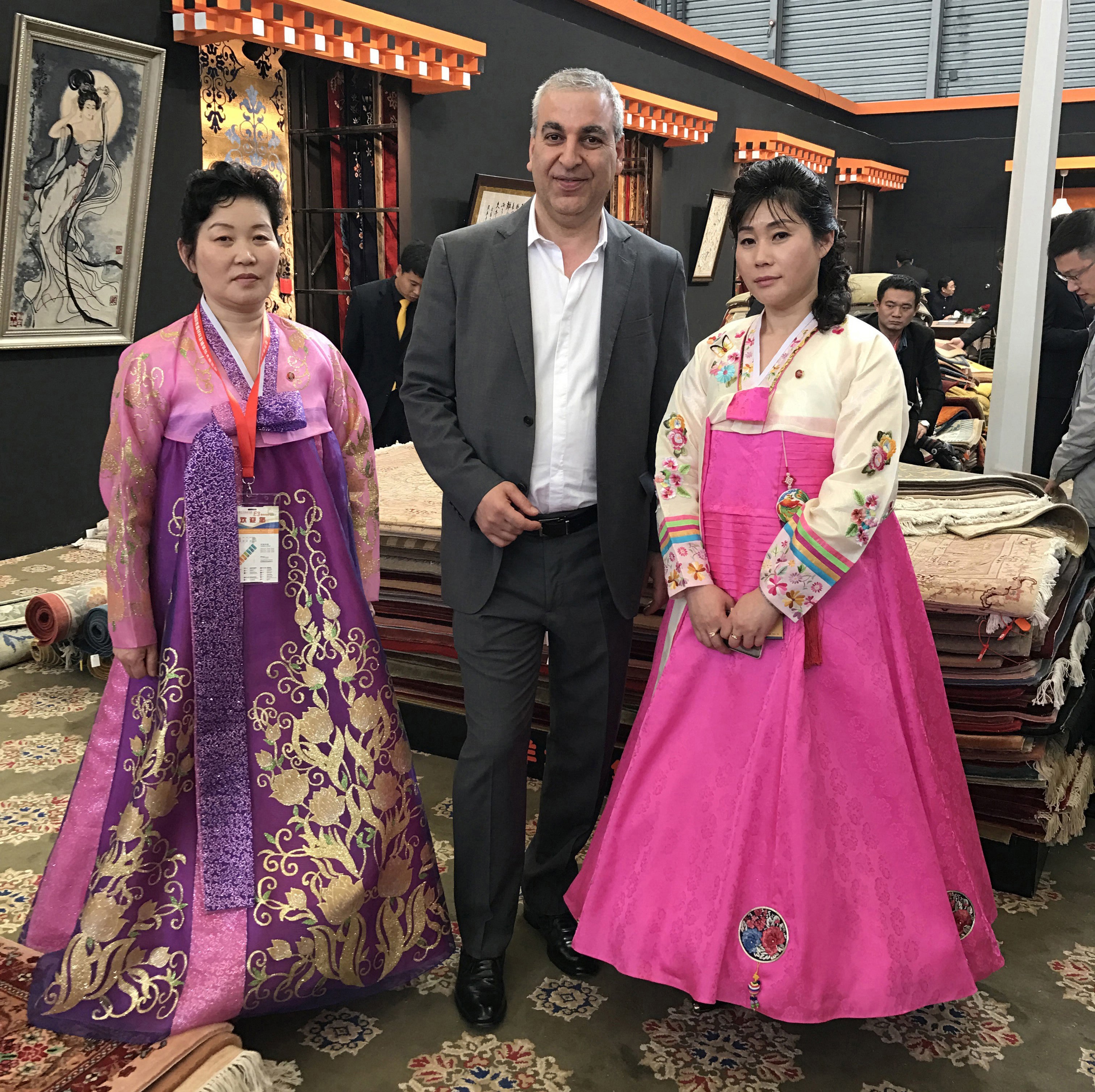 owner with two women wearing a traditional Korean dress