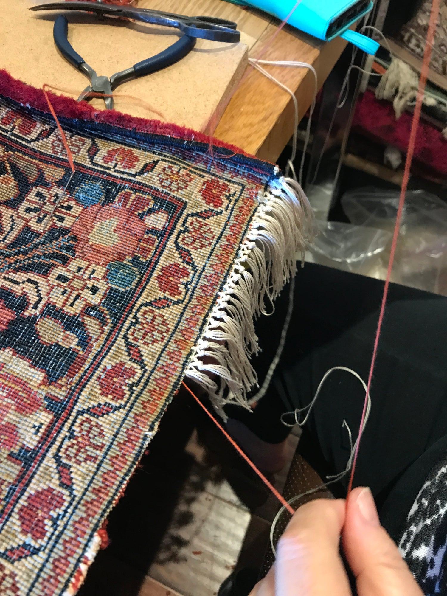 hand fixing rug fringes